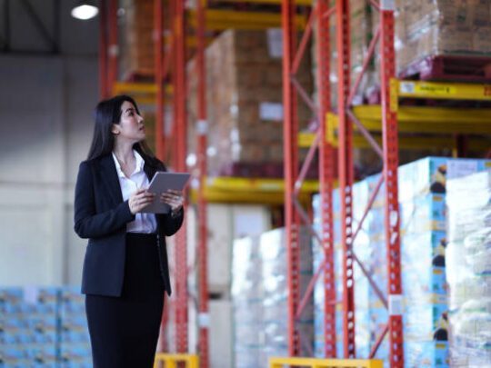 Asian Business Woman walking checking product stock using application digital tablet checklist at the warehouse