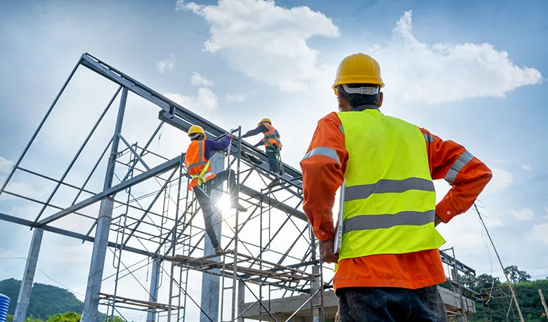 Engineer technician watching team of workers on high steel platform. Engineer technician watching team of workers on high steel platform,Engineer technician Looking Up and Analyzing an Unfinished Construction Project.